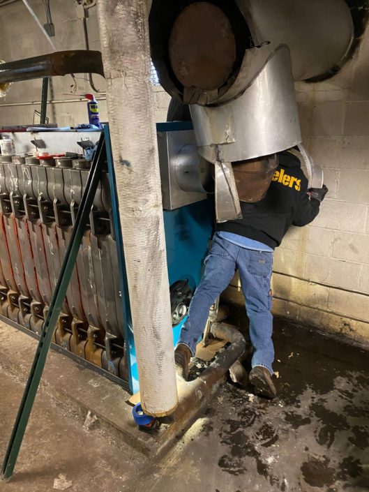 Cheltenham Youth Facility- A tech in the process of putting together a new boiler